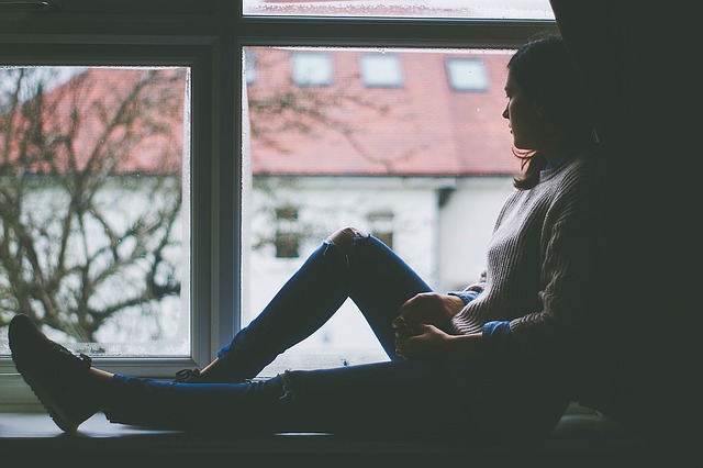 Time does not stop for a mom who has had a miscarriage. woman, window.