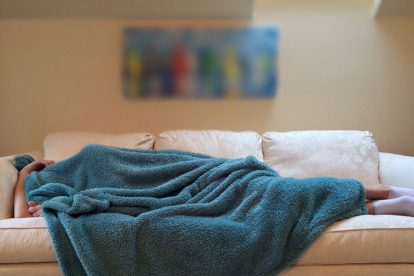 Mom who is suffering a miscarriage can't hide at home. blankets, couch, woman