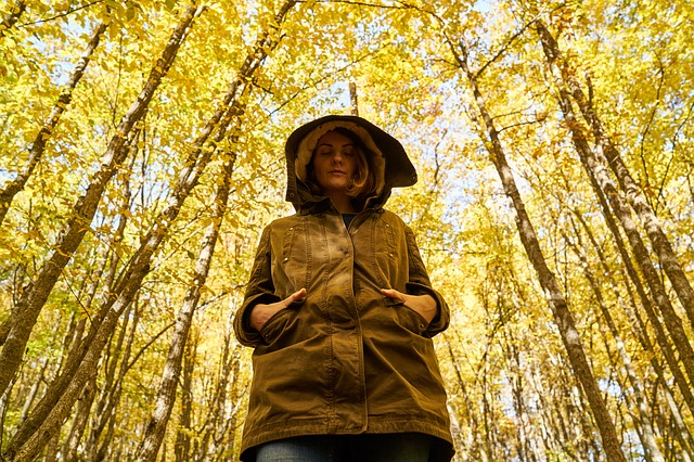 This mom kept hiking even while suffering a miscarriage. woman, forest, yellow