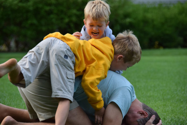 father, sons, wrestling, yellow