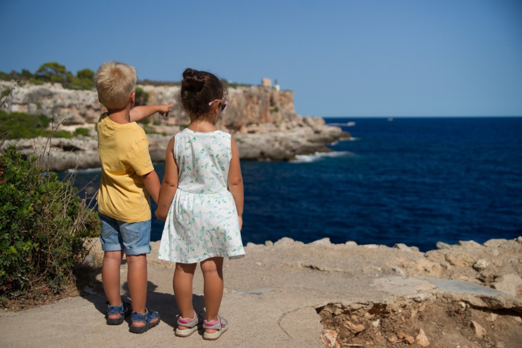 two children looking at the ocean