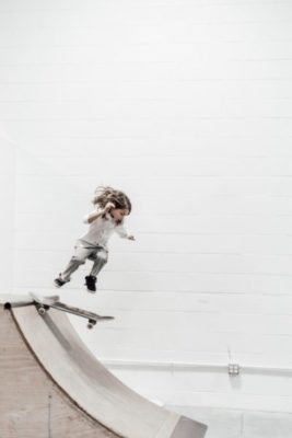 girl child with long hair skateboarding