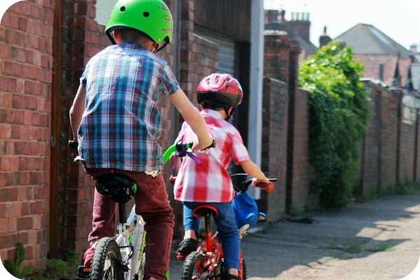 2 boys riding bicycles