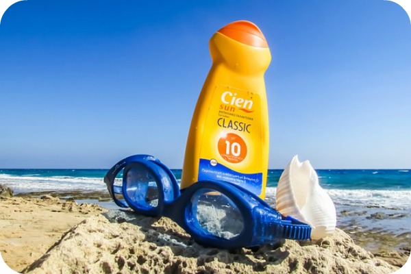 sunscreen and swim goggles