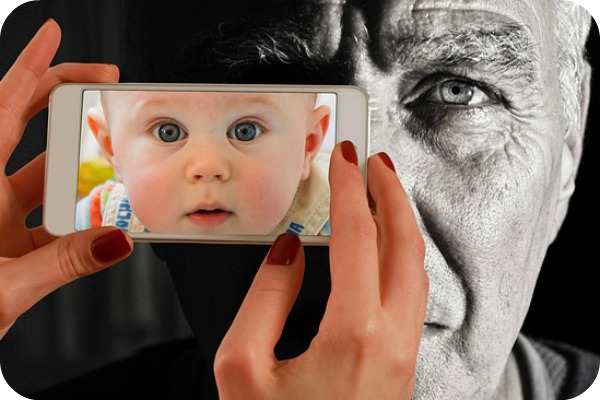 baby face in camera pointed at man