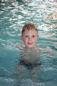 boy in the pool swimming