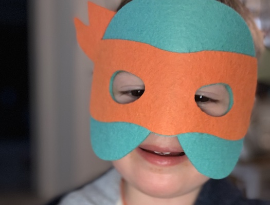 Toddler in a cartoon mask