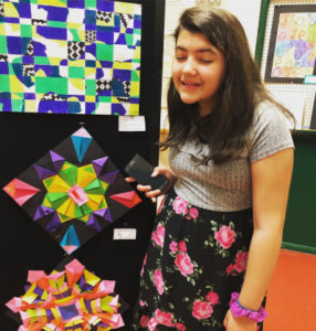 teen girl makes silly face at art exhibit