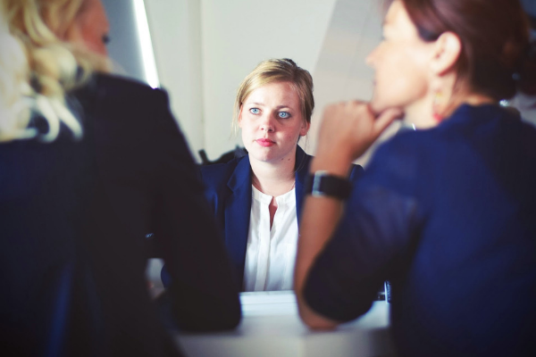 corporate job, woman with blue eyes in a business suit, disheveled