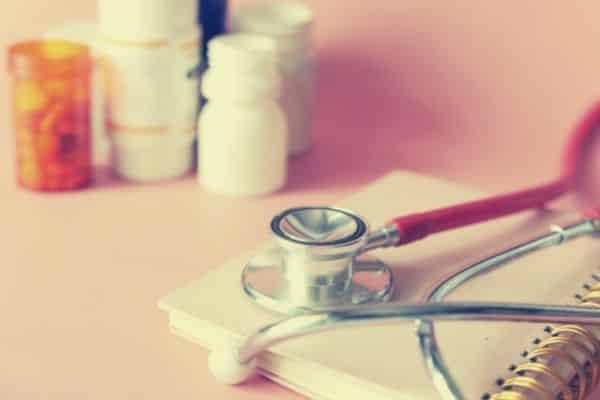 stethoscope with pill bottles in the background