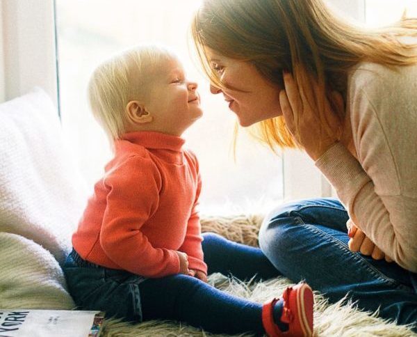 hearts full, mother and toddler smile at each other