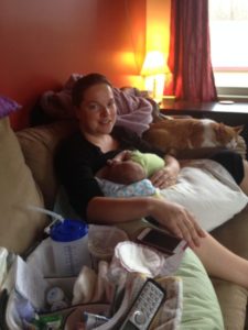 mother and nursing baby on couch- the start of a long and difficult breastfeeding journey