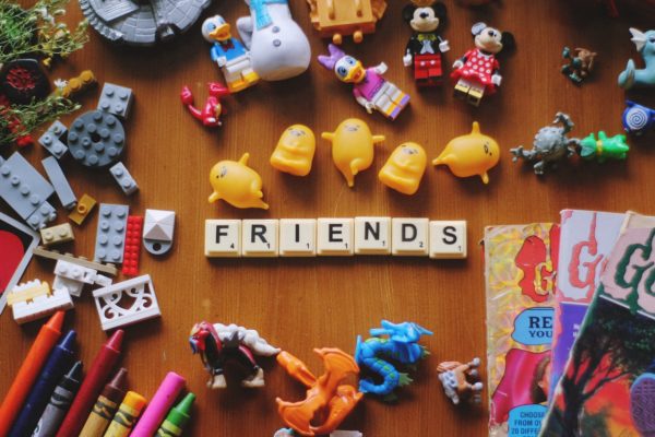 "Friends" spelled out in tiles, little toys