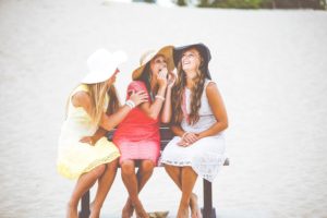 3 women siting together on a bench