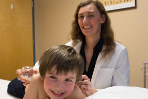 Six year old is all smiles getting cupped by acupuncturist Kerry Boyle