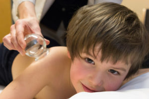 Six year old Daniel receives cupping treatment
