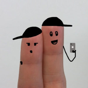 fingers with faces drawn on them, wearing hats, and taking a selfie with a cell phone
