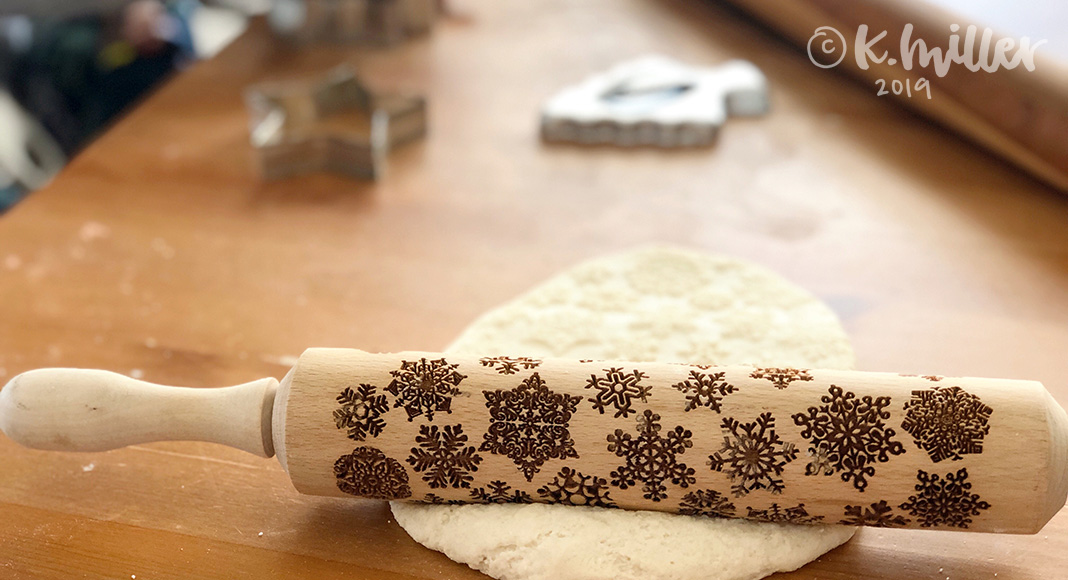 Easy Holiday Craft: Salt Dough Ornaments and Gift Tags A stamped rolling pin rolls out salt dough ornaments with cookie cutters in the background