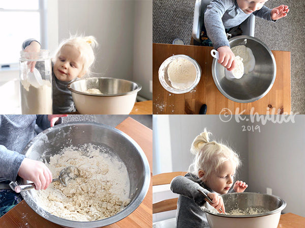 A child mixes in a large metal bowl