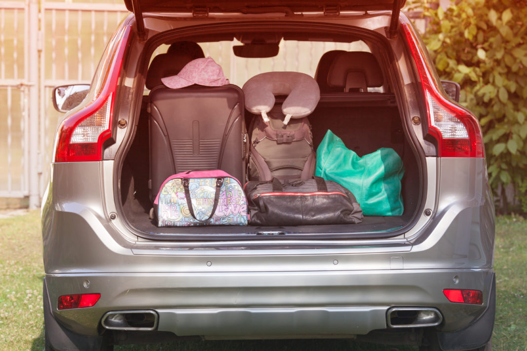 Family Road Trip Tips from a Mobile Mom with Three Kids car packed with luggage for a family road trip
