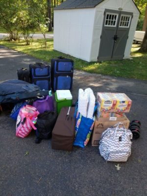 Luggage in driveway prepared for family road trip