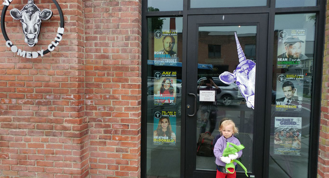 Forget French Classes, Cultivate Your Kid’s Sense of Humor Instead child in front of comedy club