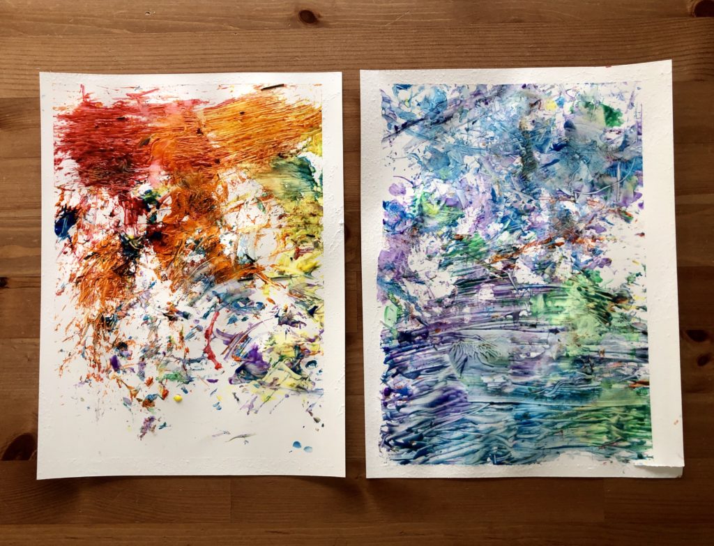 Viewed from above are two finger paintings, one in warm ones and the other in cool tones.