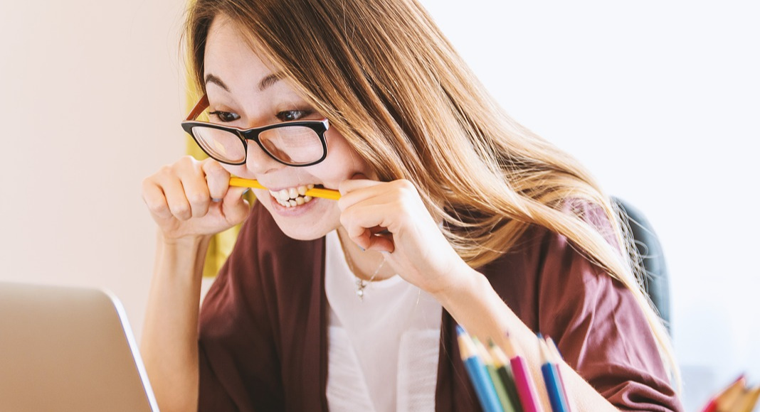 Attention Deficit Hyperactivity Disorder: Understanding My Son’s Diagnosis woman wearing glasses bites a pencil