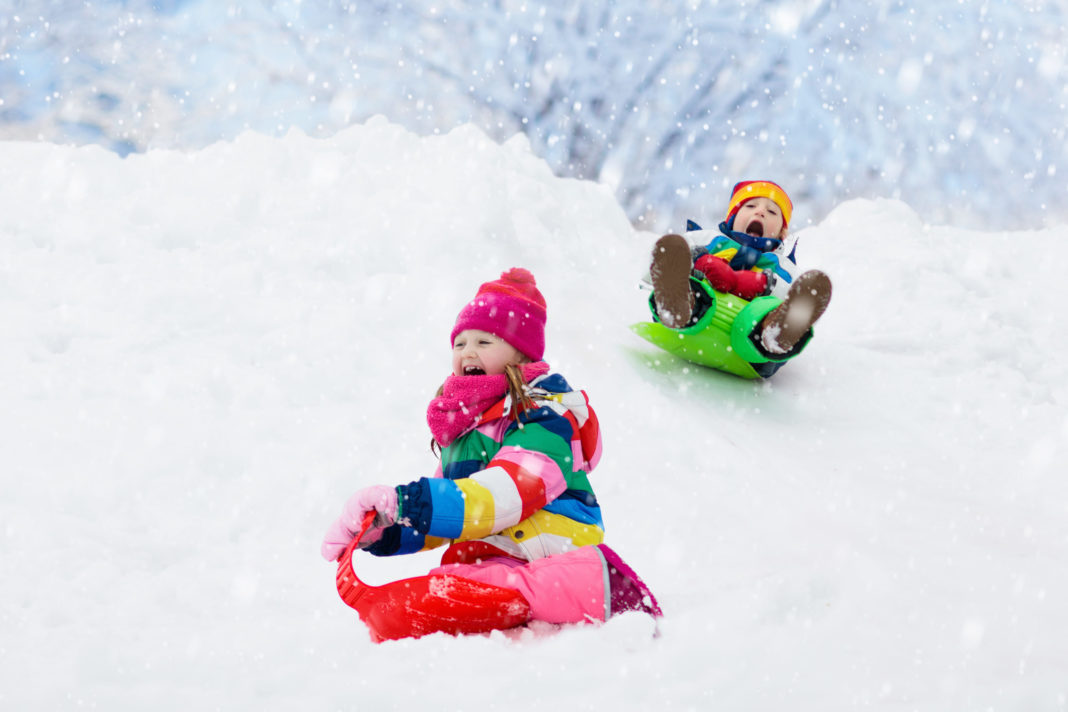 Family-Friendly Weekend Events in Vermont this January children sledding down hill