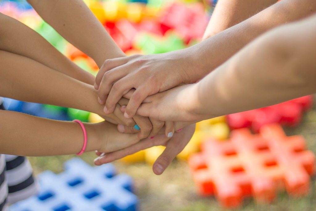 A group of children's hands in a circle