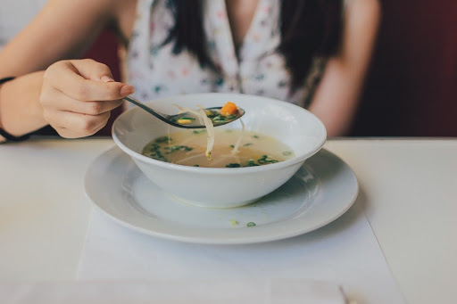 woman eating soup