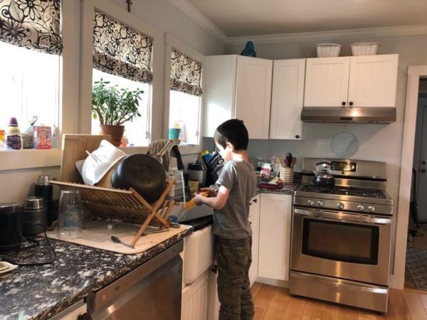 Luke does the dishes as part of our chore for money system