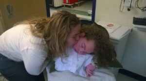 mother kisses medically fragile daughter, wishing others knew to handle with care.