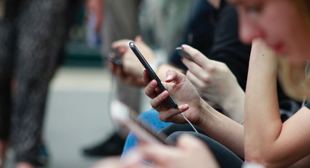 Protecting Our Kids: A Social Media Roundup for Clueless Parents people on their cell phones