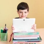 child doing homework on computer
