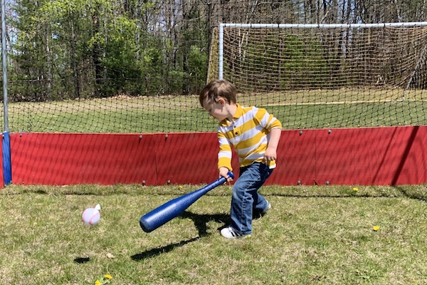 Boy playing baseball in a field