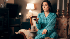 a woman binge watch TV after her kids are in bed
