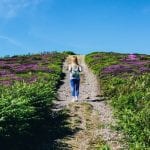 woman-walking-alone-in-between-purple-flower-field-1187005