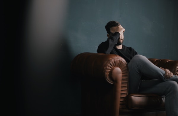troubled man sitting on couch