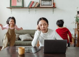 Let’s Get Real: I am Not Cut Out to Be a Stay-At-Home Mom A woman tries to work with children playing behind her