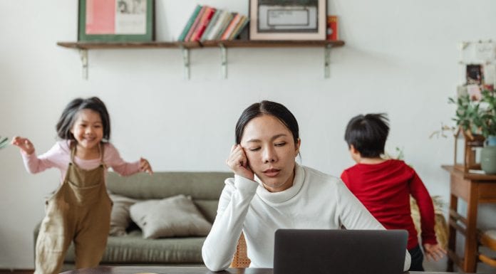 Let’s Get Real: I am Not Cut Out to Be a Stay-At-Home Mom A woman tries to work with children playing behind her