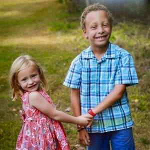 sister and brother holding hands
