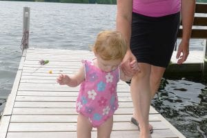 toddler walking holding hands with mom