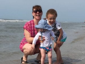 mother with two young children at the beach