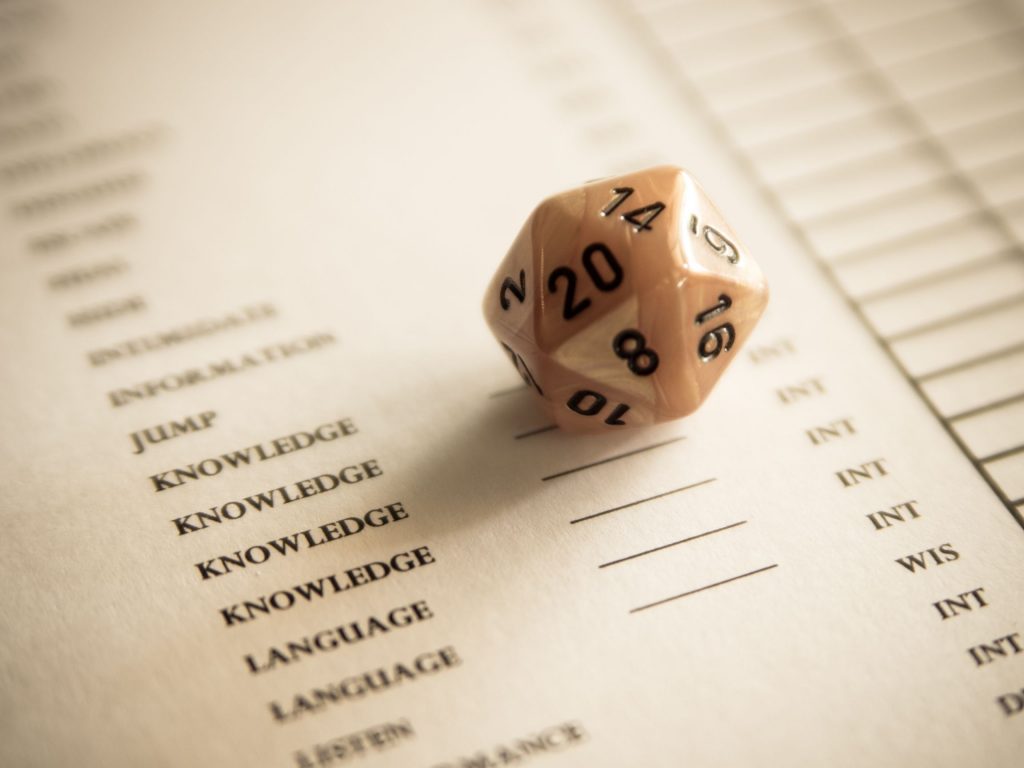 A 20 sided dice on a character sheet for role playing games