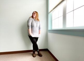 I Don’t Care if My Leggings Offend You: In Defense of my Casual Style A woman in leggings and a gray sweatersmiles