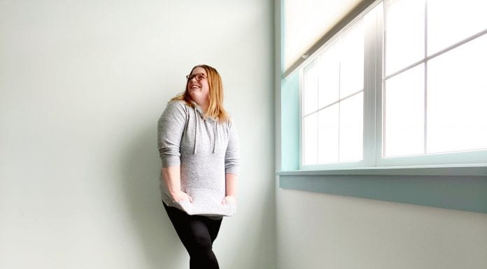 I Don’t Care if My Leggings Offend You: In Defense of my Casual Style A woman in leggings and a gray sweatersmiles