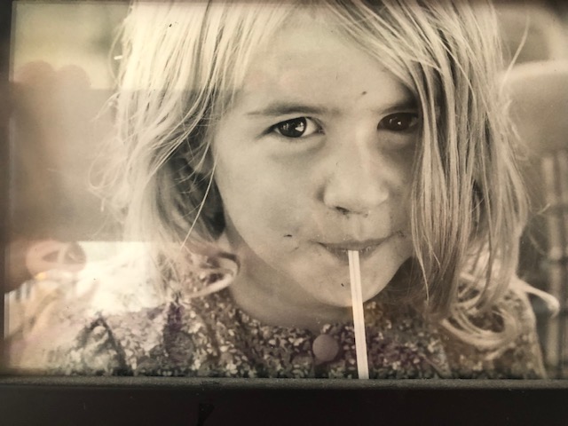 young girl drinking out of a straw