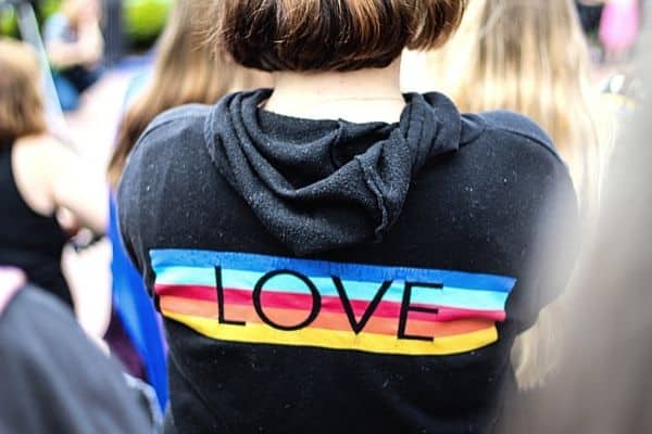 sweatshirt that says "love" on the back, with a rainbow
