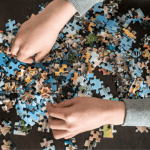 hands over a puzzle